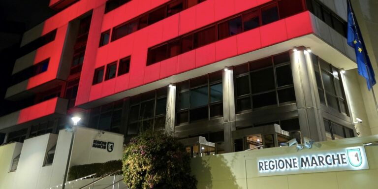 La sede della Regione Marche si tinge di rosso: «Impegno che non può fermarsi»
